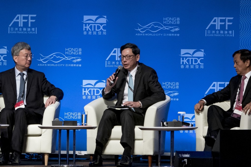 HKMA chief executive Norman Chan Tak-lam (centre) speaks as Zhu Min, head of Tsinghua University’s national institute of financial research (left), and Charles Li Xiaojia, chief executive of Hong Kong Exchanges and Clearing, look on, at the Asian Financial Forum in Hong Kong on January 16. Photo: Bloomberg