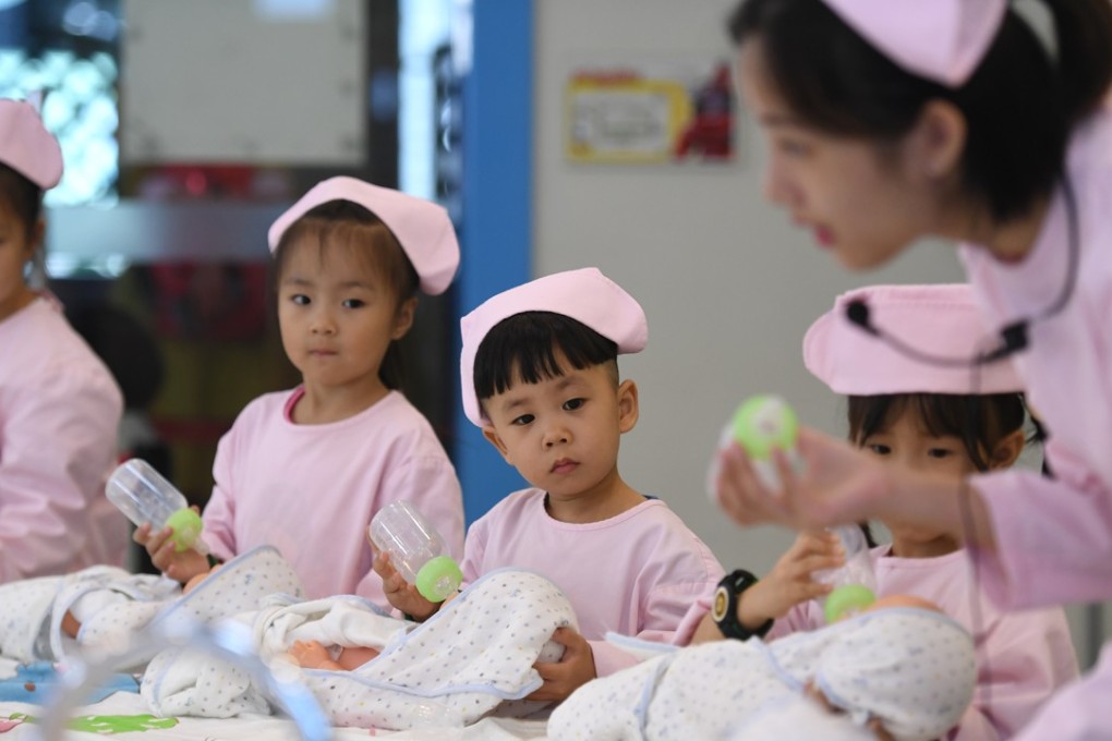 Children practise feeding babies in Hangzhou in 2017. China’s move to a two-child policy in 2015 has not dramatically increased the birth rate. Photo: Xinhua