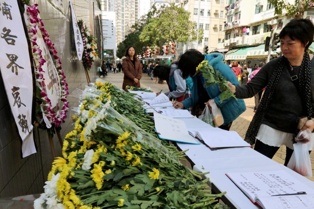 People pay their respects to the bus crash victims outside the Tai Po Hui Market and Cooked Food Centre in Hong Kong. Photo: Felix Wong
