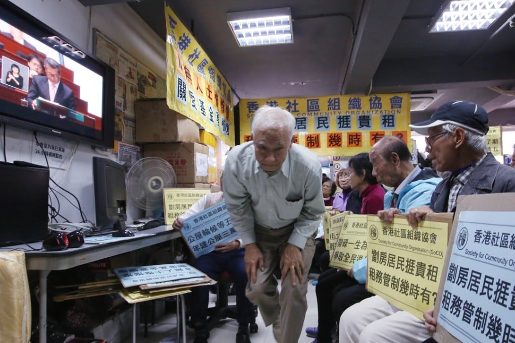 Elderly citizens in Sham Tsui Po watch Financial Secretary Paul Chan Mo-po deliver his budget for 2017-2018 in February last year. Photo: Edmond So