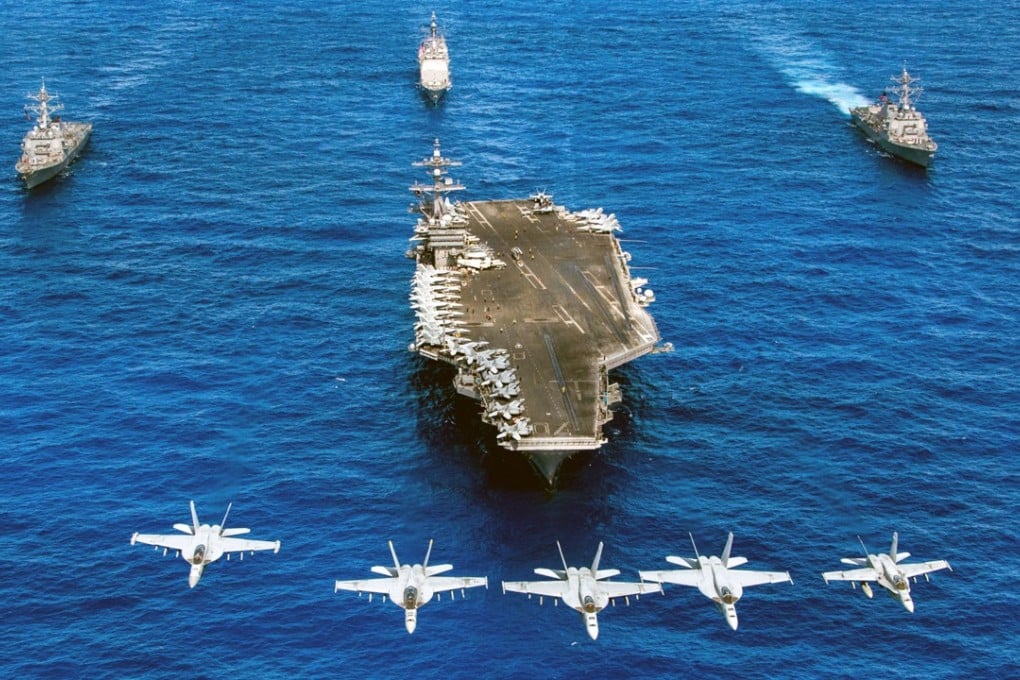 Super Hornet fighter jets fly over the Nimitz-class aircraft carrier USS Carl Vinson. Photo: AFP