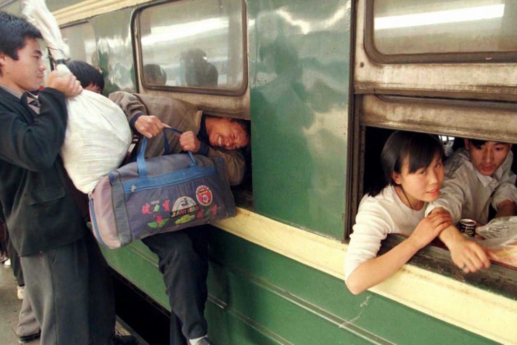 Travellers try to squeeze through the window of a train at Guangzhou Railway Station during the Lunar New Year exodus in February 1999. Photo: Reuters