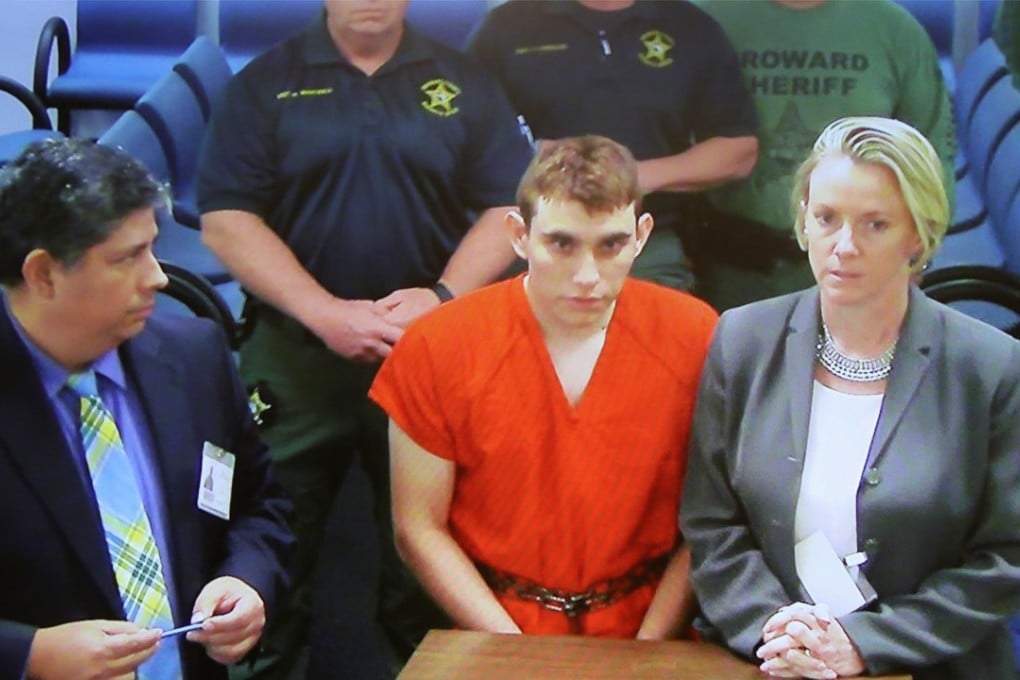Nikolas Cruz (centre) appears via video monitor with Melisa McNeill (right), his public defender, at a bond court hearing after being charged with 17 counts of premeditated murder, in Fort Lauderdale, Florida, on Thursday. Photo: Pool via Reuters
