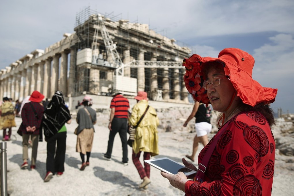A Chinese tourist at the Parthenon in Athens. China’s tourism industry has emerged as the top beneficiary of the “Golden Week” over the past decade. Photo: Bloomberg
