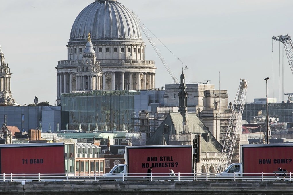 The community-led organisation, Justice4Grenfell, parades three billboards backdropped by St. Paul's Cathedral as they move around London. Photo: AFP