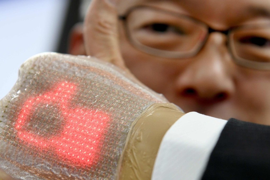 A man wearing an ultra-thin elastic ‘skin’ equipped with an LED display that can monitor important health data as well as send and receive messages, including emojis. Photo: AFP