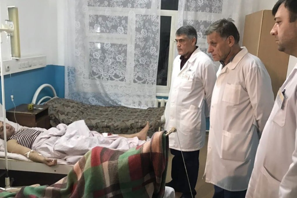 Doctors examine the wounded man in the hospital after a shooting at a church in Kizlyar, Dagestan. Photo: EPA