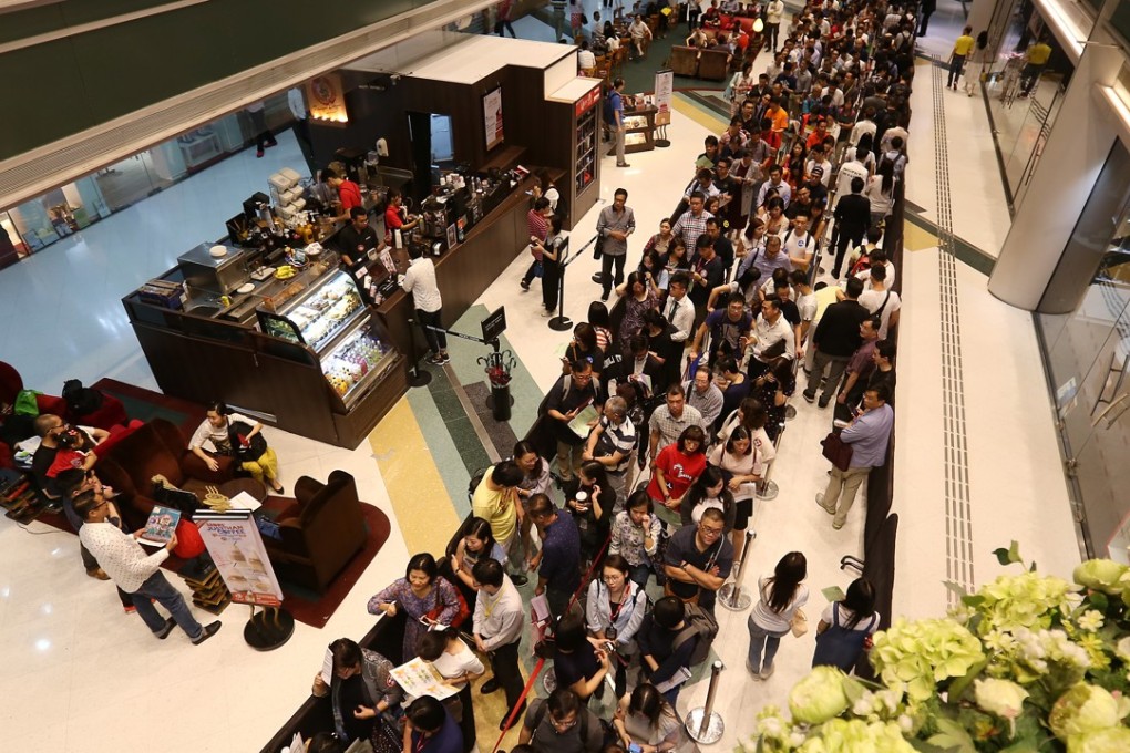 Potential buyers line up for a residential project in Tsuen Wan last July. A demand-supply gap is seeing more people compete for a limited number of flats in Hong Kong. Photo: Xiaomei Chen