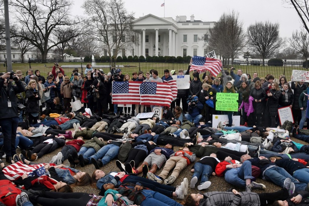 Children, teens and adults take part in a ‘lie-in’ on the road outside the White House on Monday to protest lax gun laws following the murder of 17 students and staff at Marjory Stoneman Douglas High School in Parkland, Florida, last week. Photo: Abaca Press via TNS
