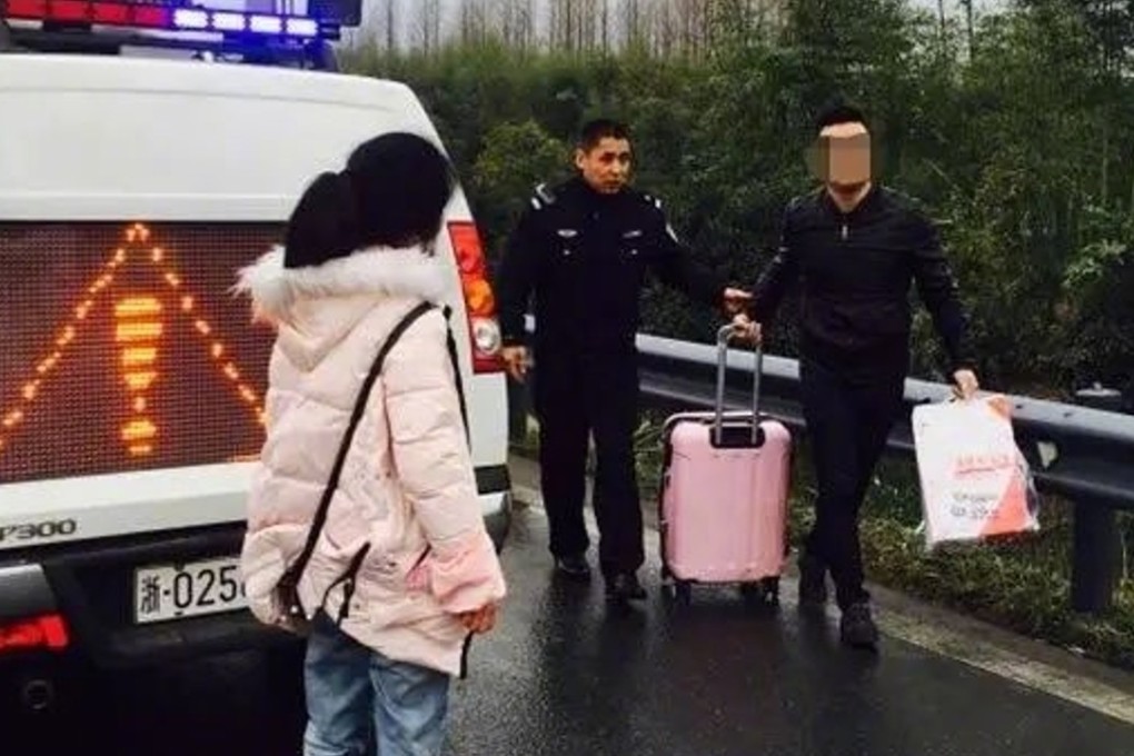 People help to resolve a dispute between a couple in eastern China on Sunday. Photo: Weibo