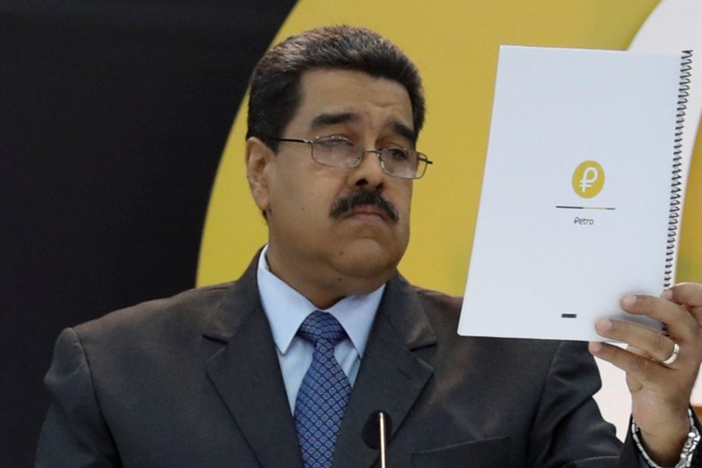 Venezuela's President Nicolas Maduro reads a document during the event launching the new Venezuelan cryptocurrency ‘Petro’ in Caracas. Photo: Reuters