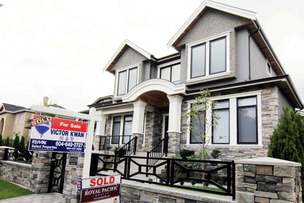 Realtor signs are hung outside a newly sold property in a neighbourhood where houses regularly sell for over a few million dollars in Vancouver. File photo: Reuters
