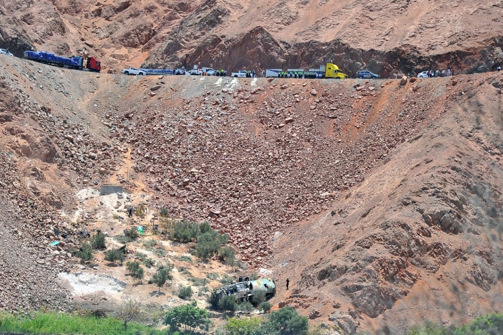 Rescuers at the scene where the bus fell into a ravine. Photo: Reuters