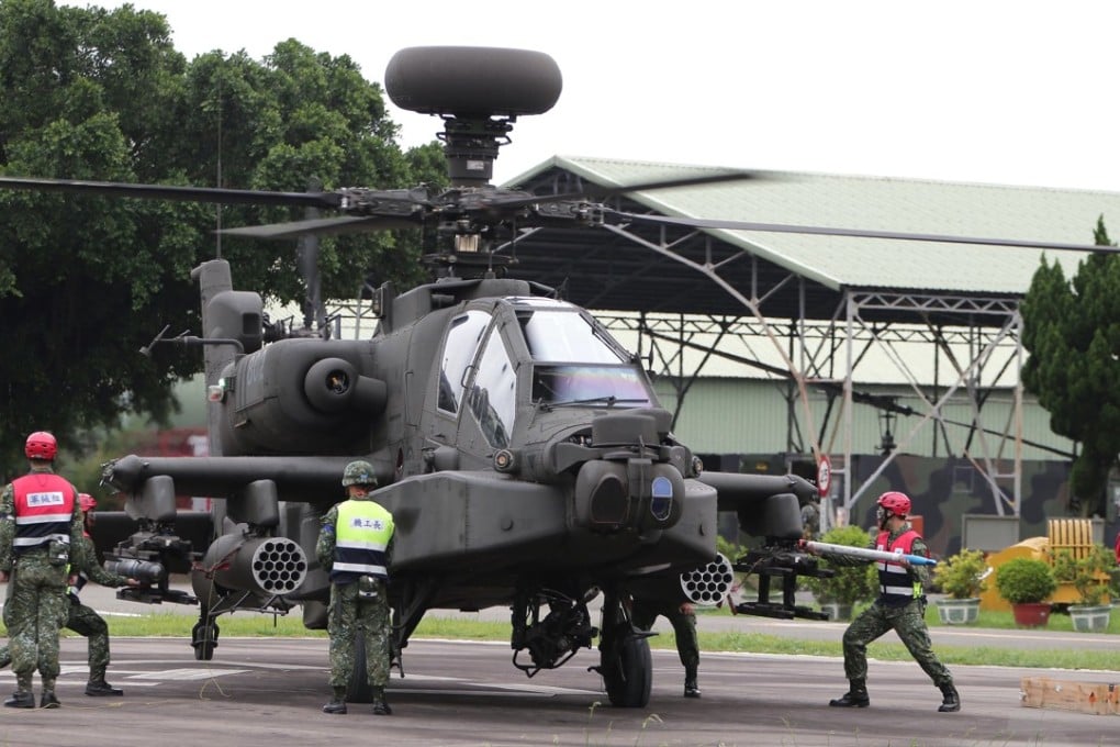 A handout photo shows a soldier attaching a missle to a Taiwan Army AH-64 miltiary helicopter at the Hsinchu Air Base in Hsinchu, western Taiwan, 22 May 2017, kickstarting the annual military drill. Photo: EPA