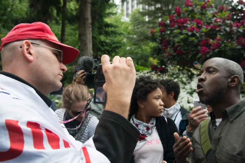A Trump supporter and an opponent debate during a pro-Trump rally seven months after his election. America has neglected its tribal divisions – racial, political and between rich and poor – Amy Chua argues in her new book. Photo: AFP