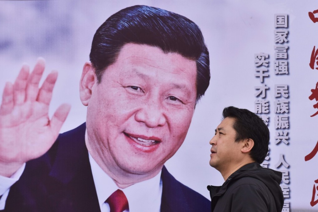 A man walks past a poster of Chinese President Xi Jinping with the slogan “Chinese Dream, People’s Dream” in Beijing on October 16, 2017. Photo: AFP