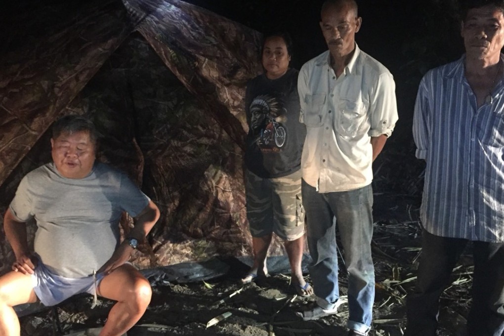 Premchai Karnasuta, 63, left, at his campsite where he and others in his group were arrested by Thai wildlife authorities. Photo: AP