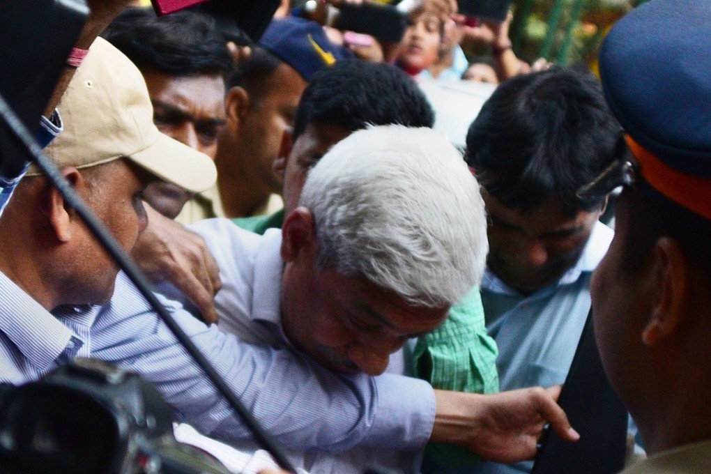 Gokulnath Shetty, centre, the former deputy manager of the Punjab National Bank, is escorted into a Mumbai court. Photo: AFP