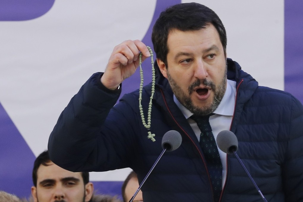 Leader of The League party Matteo Salvini shows a rosary as he addresses a rally in Milan, Italy. Photo: AP