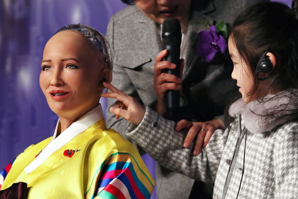 A child touches the robot Sophia, developed by a Hong Kong-based company, during a conference on artificial intelligence in Seoul. As machines threaten to displace human beings from some jobs, cultivating creativity in children has become more crucial. Photo: Yonhap