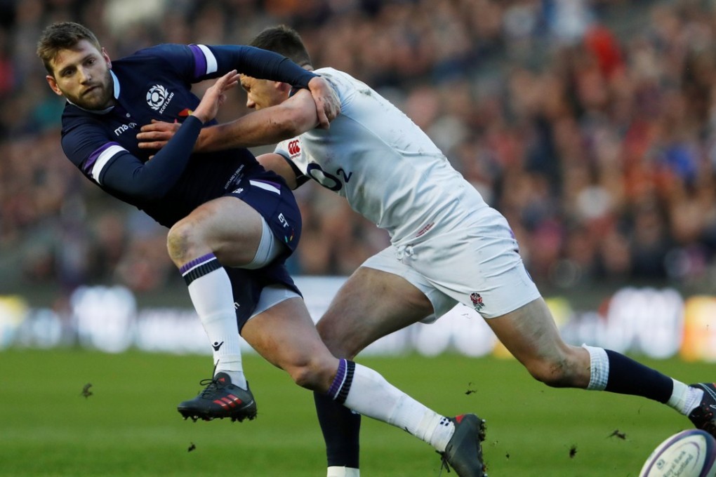 Scotland’s Finn Russell is tackled by England’s Owen Farrell. Photo: Reuters