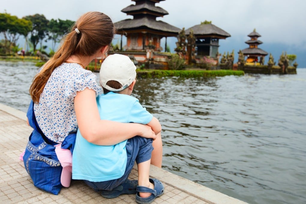 Shutterstock image shows Mother and son enjoying views of beautiful Bali water temple at Bratan lake [27FEBRUARY2018 FEATURES]