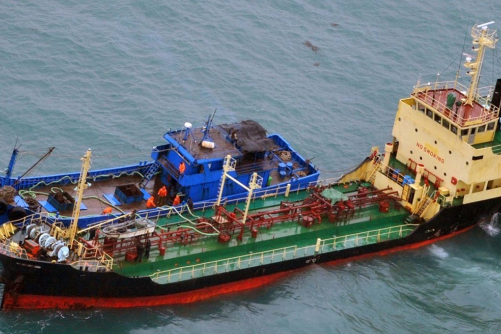 Japan's ministry of defence says this February 16 photo shows a North Korean-flagged tanker, Yu Jong 2 (bottom), and an apparent Chinese ship, Min Ning De You 078, appearing to transfer something in violation of UN sanctions on North Korea. Photo: Japanese Ministry of Defence via AP