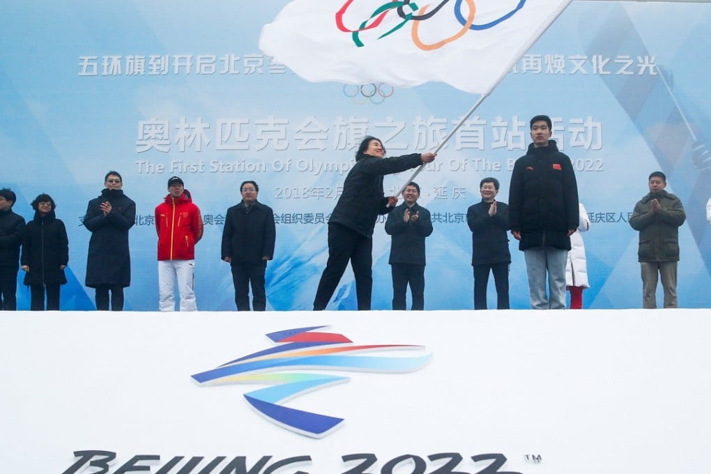 Secretary general of the Beijing organising committee for the 2022 Olympic and Paralympic Winter Games, Han Zirong, waves the Olympic flag during a handover ceremony. Photo: Reuters
