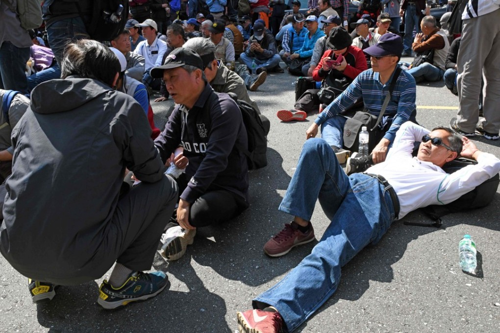 Protesters gather outside parliament in Taipei on Tuesday during a demonstration against the government’s pension reform plan. Photo: AFP
