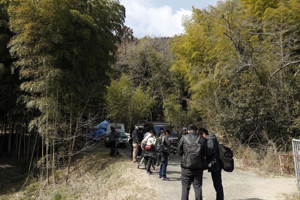 Journalists gather near the location where body parts believed to be those of a missing woman were found in Osaka, western Japan, on Monday. Photo: Yuki Sato/Kyodo News via AP