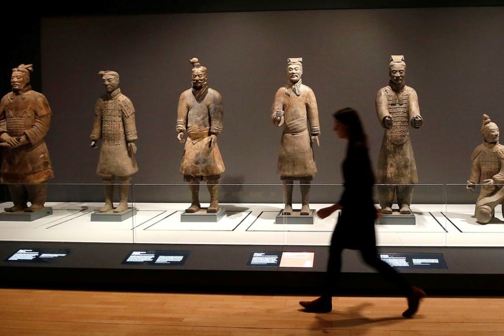 A woman walks past a display of terracotta warriors on loan from China to the World Museum in Liverpool, Britain. Photo: Reuters