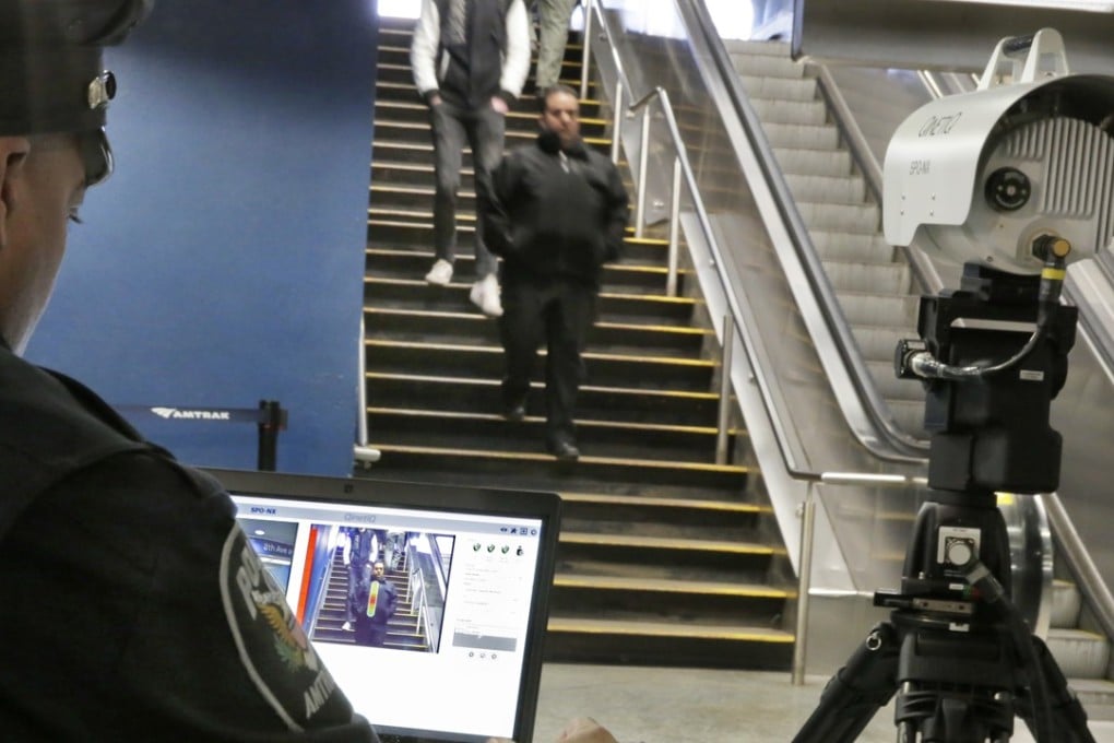 An Amtrak police officer uses a QinetiQ SPO-NX suicide vest-detection device to reveal a suspicious object on a man, at left, during a Transportation Security Administration demonstration in New York's Penn Station on Tuesday. Photo: AP