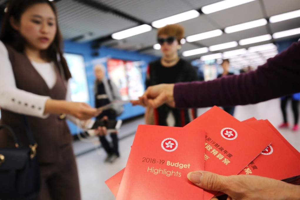 The budget highlights being handed out to the public in Kowloon Tong. Photo: Winson Wong