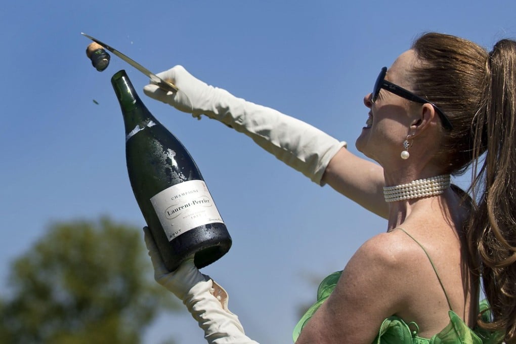 Using a technique known as sabrage, sommelier Catherine Fallis opens a bottle of champagne with a blade. Pictures: Alamy