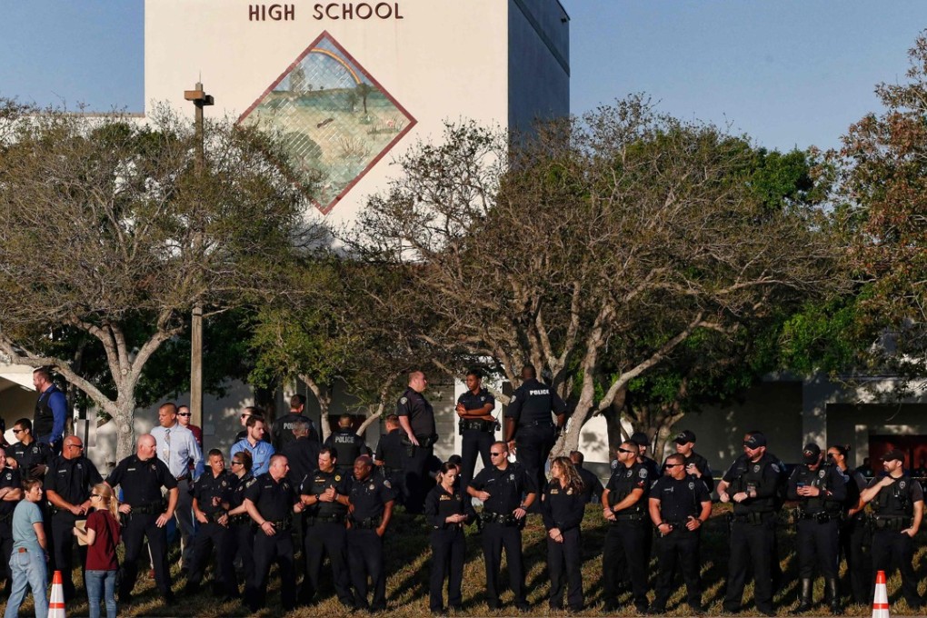 Marjory Stoneman Douglas High School staff, teachers and students return to school greeted by police and well wishers in Parkland, Florida on Wednesday, two weeks after 17 people were shot dead at the school. Photo: AFP