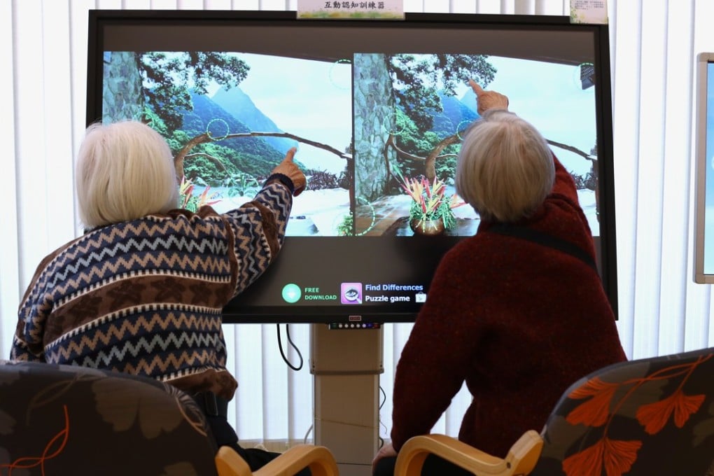 Two elderly women try out a touchscreen at the Tung Wah Group of Hospitals’ Jockey Club Sunshine Complex dedicated to older citizens, in Wong Chuk Hang on February 13. Photo: Nora Tam