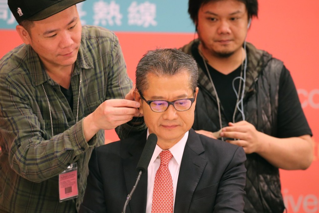 Financial Secretary Paul Chan Mo-po (centre) gets ready for a radio phone-in programme to answer questions from the public on the 2018-19 budget. Photo: Dickson Lee
