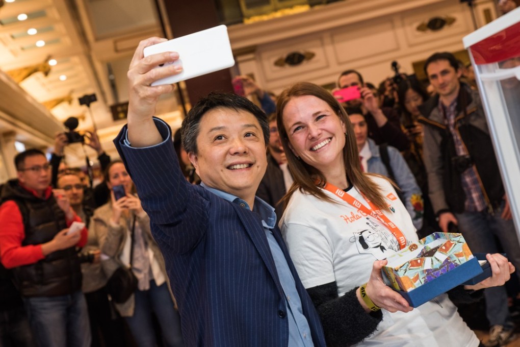 Xiang Wang (left), Xiaomi’s senior vice president, poses for a selfie with a staff member at the opening of a new Mi store in Barcelona on the weekend. Photo: Handout