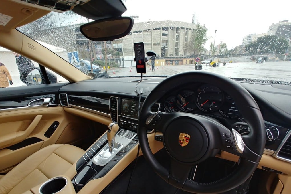 The Huawei Mate 10 Pro smartphone sitting above the dashboard of the Porsche Panamera drove the car around different objects using its AI capabilities.