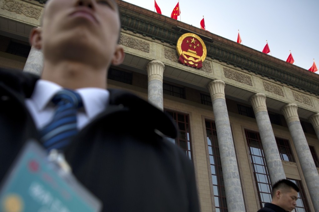 Security staff stand guard outside the Great Hall of the People in Beijing on Friday, ahead of the annual meeting of China’s top political advisory body. Photo: AP