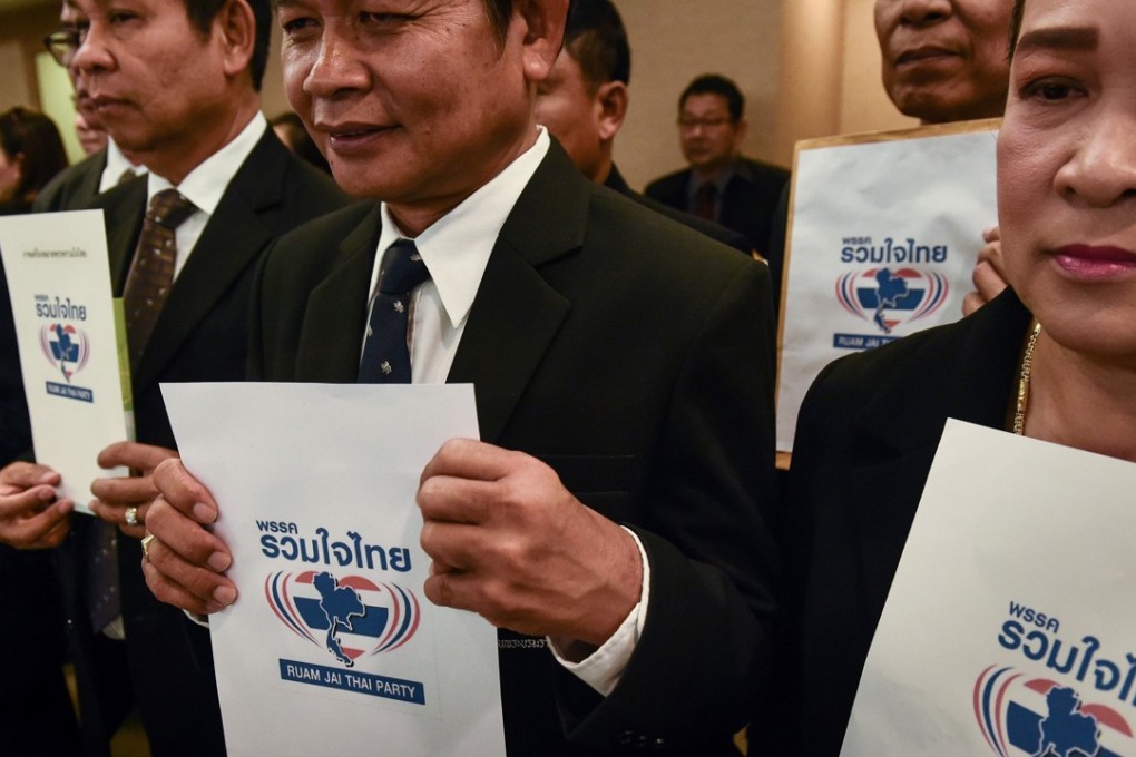 Members of the Ruam Jai Thai Party wait to submit paperwork for the registration of their political party at the Office of the Election Commission of Thailand on March 2, 2018. Photo: AFP