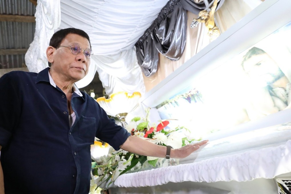 A handout photo shows Philippine President Rodrigo Duterte viewing the coffin of Overseas Filipino Worker Joanna Demafelis during a wake in the town of Sara, Iloilo province on February 22 2018. Duterte has said he is old and tired and wants to finish his presidential term early. Photo: EPA-EFE/Philippine Presidential Photographs Division (PPD)