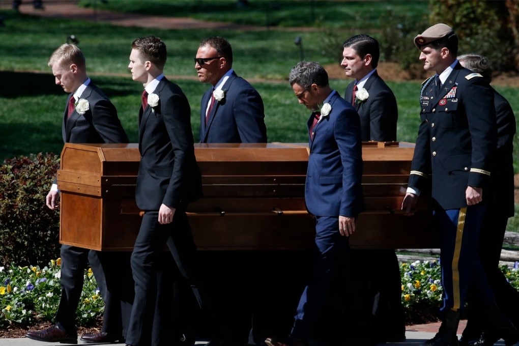 A casket carrying the body of Reverend Billy Graham is carried to his funeral service at the Billy Graham Library on Friday in Charlotte, North Carolina. A spiritual counselor for every president from Harry Truman to Barack Obama and other world leaders for more than 60 years, Graham died February 21 at the age of 99. Photo: Getty Images via AFP