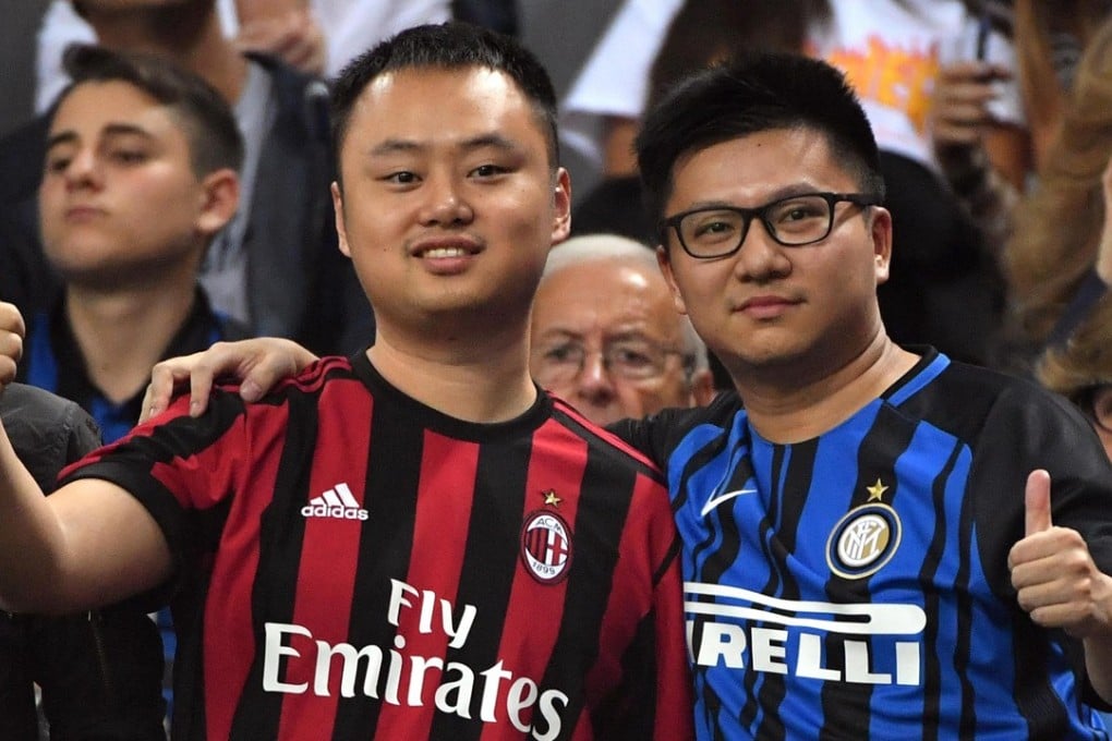 Two supporters of Inter Milan and AC Milan attend the Serie A match between the clubs at the Giuseppe Meazza stadium in October 2017. Photo: EPA