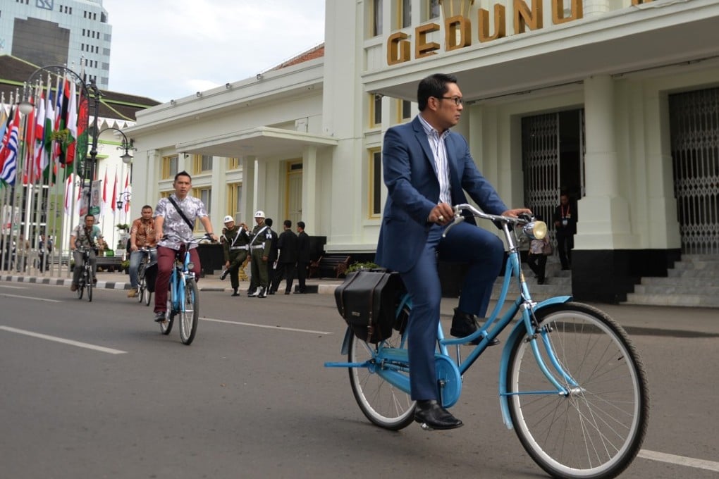 Mayor Ridwan Kamil rides through Bandung city. Photo: AFP