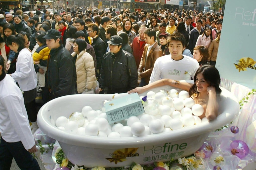 A model in Causeway Bay, Hong Kong, promotes skin whitening products. Photo: AFP