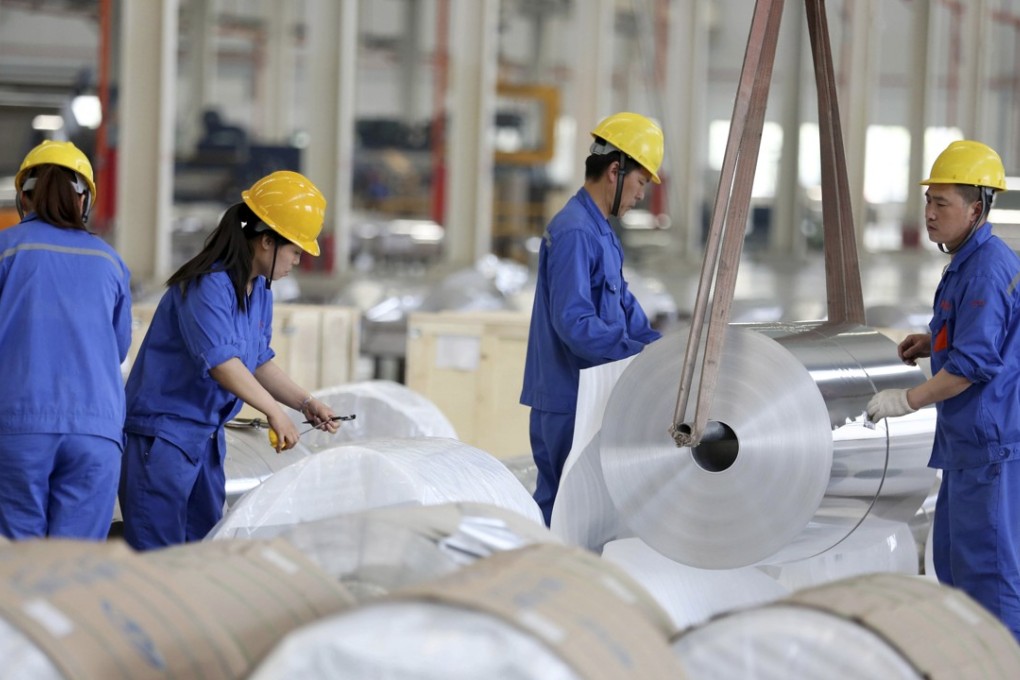 Chinese workers packaging aluminium at a production plant in Anhui province. Photo: AFP