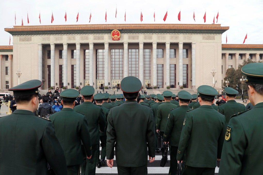 Military delegates arrive for the opening session of the National People's Congress at the Great Hall of the People in Beijing on Monday. The headline announcements was an 8.1 per cent rise in defence spending, and tougher controls on pollution. Photo: Reuters