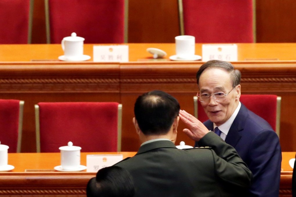 General Fan Changlong salutes former anti-graft tsar Wang Qishan as he leaves after the opening session of the National People's Congress at the Great Hall of the People in Beijing on Monday. Photo: Reuters