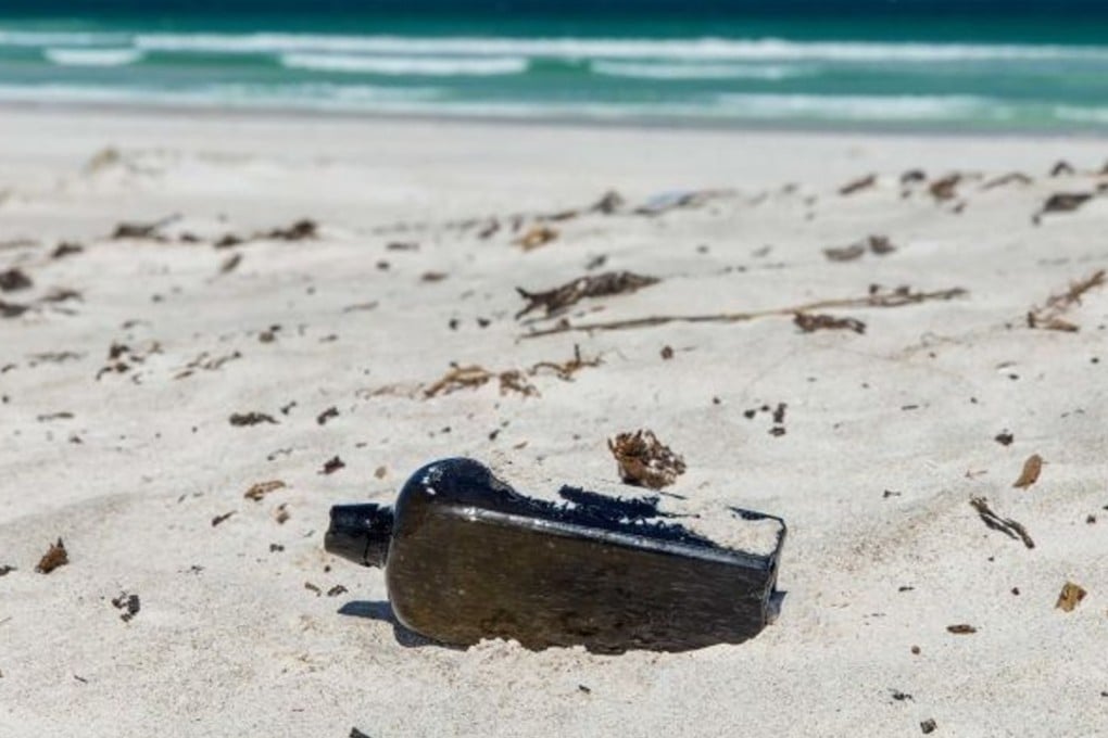 Tonya Illman found the 132-year-old gin bottle in the dunes near Wedge Island, Western Australia. Photo: Kym Illman